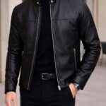 Man wearing a black leather biker jacket, black turtleneck, and black jeans.